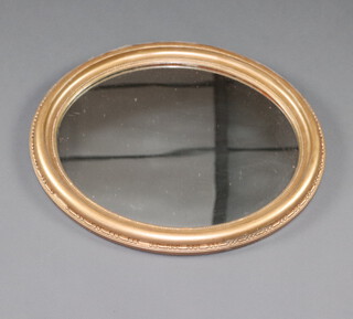 A 19th Century oval plate wall mirror contained in a decorative gilt painted frame 58cm h x 50cm w 