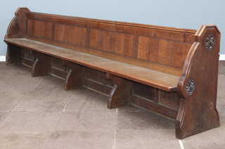 A large and impressive Victorian carved oak and panelled pew by S S Teulon, the aisle end carved a pair of rosettes and with brass plaque to the end marked number 12, 87cm h x 364cm w x 47cm d, this pew was removed from the Horsham Parish Church of St Mary The Virgin 