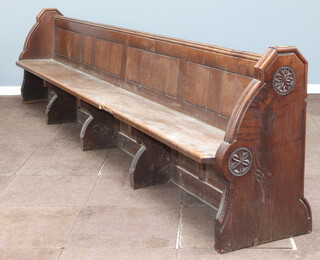 A large and impressive Victorian carved oak and panelled pew by S S Teulon, the aisle end carved a pair of rosettes and with brass plaque to the end marked number 6, 87cm h x 364cm w x 47cm d, this pew was removed from the Horsham Parish Church of St Mary The Virgin 