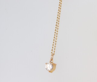 A yellow metal pendant with single stone brilliant cut diamond, pendant approx. 0.25ct, on a yellow metal chain 38cm 