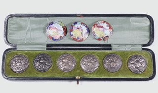 A set of 6 Victorian silver repousse buttons decorated with Reynolds angels in original fitted case together with 3 enamelled brass buttons 