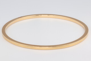 A yellow metal (acid tested as at least 14ct) plain bangle, 21.8 grams 6cm diam. 