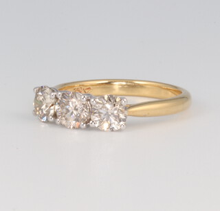 An 18ct yellow gold 3 stone brilliant cut diamond ring, approx. 1.55ct, size M, 3.5 grams 