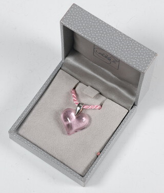 A Lalique pink glass heart shaped pendant 25mm, on a silk pink necklace 72cm, boxed 