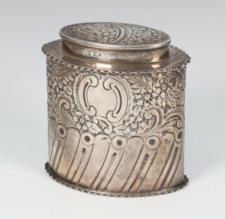 A George V repousse silver oval tea caddy decorated with demi-fluted and floral decoration Sheffield 1911, 8.5cm, 119 grams 