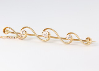 A yellow metal 15ct 3 stone diamond bar brooch, approx. 0.4ct, 4.4 grams, 85mm