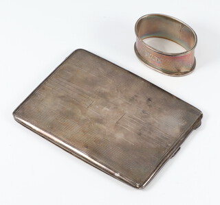 An Art Deco silver engine turned cigarette case Birmingham 1931 with engraved monogram together with a napkin ring 134 grams 