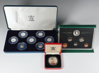 A Sri Lankan 500 rupee silver proof coin, 7 silver proof commemorative proof one pound coins and an uncirculated coin set  