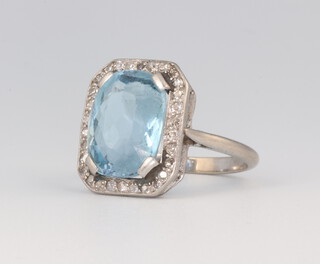 A white metal aquamarine and diamond cocktail ring, the centre stone 15mm x 10mm, 5.1 grams, size K