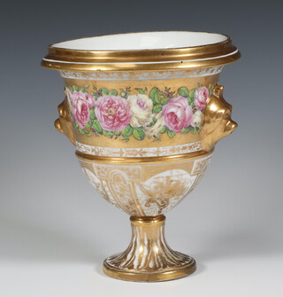 A 19th Century gilt vase with mask handles and bands of flowers decorated with panels of instruments 20cm 