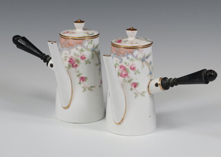 A pair of Copeland china coffee pots and lids decorated with flowers, having turned wood handles 11cm (1 is cracked)