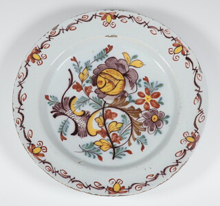 An 18th Century Continental Delft plate decorated with stylised flowers 35cm 