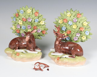 A pair of modern Dresden figures of reclining deer with floral bocage (2 broken) 