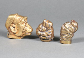 An embossed gilt metal vesta case in the form of a monkey's head 5cm together with 2 others in the form of dogs heads 4cm 