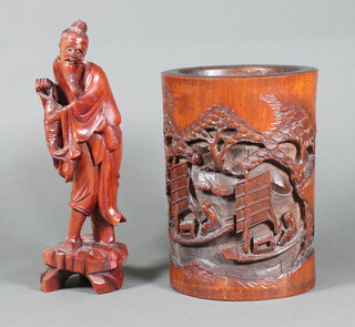 A Chinese carved hardwood figure of a standing fisherman 24cm, a bamboo vase with carved decoration 20cm h 