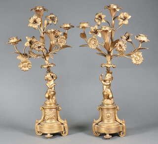 A pair of 19th/20th Century gilt metal 4 light candelabrum supported by cherubs 46cm x 27cm  