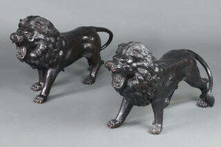 An impressive pair of 20th Century cast bronze figures of walking lions 45cm h x 82cm w x 21cm d 