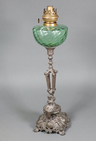 A Victorian oil lamp with green glass reservoir raised on a pierced metal base decorated a seated lady 50cm h (no shade or chimney) 