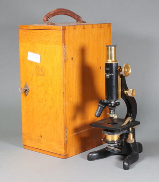 W Watson and Sons, a "Kima" single pillar microscope in a light oak carrying case 