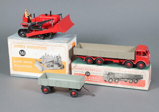 Dinky Supertoys, a Foden diesel 8 wheeled wagon with red cabin chassis and ridged hubs and hook, (play worn cab) boxed together with an unboxed large grey trailer no. 428 with red hubs and a Bloorknox Bulldozer 561 red body, green tracks, black wheels and beige driver, boxed with insert 
