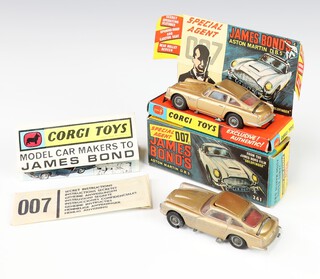 Corgi Toys, a James Bond Goldfinger Aston Martin DB5 in gold no.261, boxed with insert, unsealed secret instructions and folded Corgi brochure, together with 1 unboxed playworn DB5 