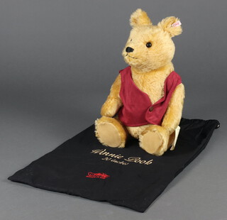 A Steiff Winnie the Pooh Bear 20cm, no.02508, no certificate, contained in a black cloth bag 