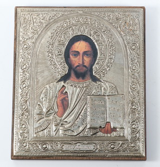 A 20th Century icon showing a print of Christ in a white metal repousse oklad bearing hallmarks 14cm x 12cm