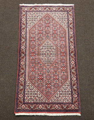 A blue, white and red ground Bijar rug with diamond shaped medallion to the centre 137cm x 67cm 