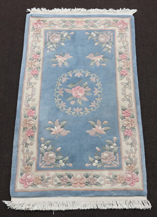 A blue and floral patterned Chinese rug 160cm x 92cm 