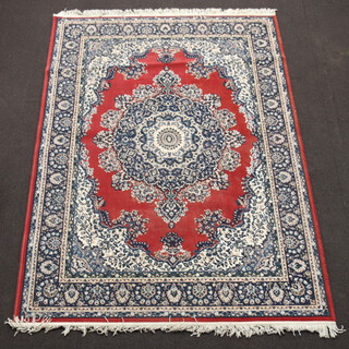 A red, blue and white ground Persian style machine made rug with central medallion 228cm x 170cm 