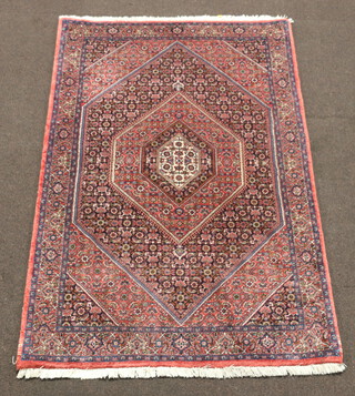 A red, white and blue Bijar rug with diamond shaped central medallion 180cm x 112cm, signed VDH to the edge  