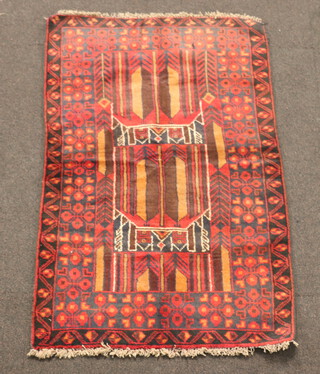 A red and black ground Belouche rug with central medallion within multi row border 134cm x 84cm 