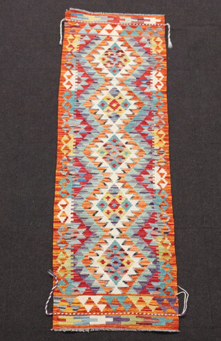 A white and orange ground Chobi Kilim runner with all over geometric design  193cm x 62cm 