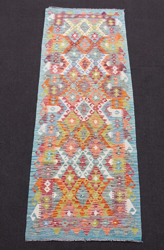 A yellow and turquoise ground Chobi Kilim runner with all over geometric design 240cm x 83cm 