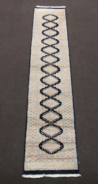 A blue, white and pink ground Bokhara runner with 13 diamonds to the centre 233cm x 64cm 