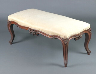 A Victorian carved rosewood show frame stool of serpentine outline, raised on cabriole supports 43cm h x 108cm w x 55cm d 