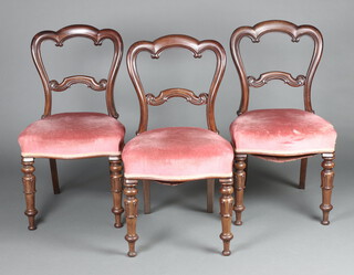 A set of 3 Victorian mahogany balloon back dining chairs with carved mid rails, raised on turned supports 89cm h x 48cm w x 46cm d 