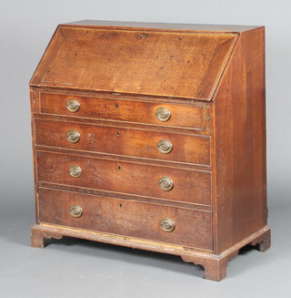 A Georgian oak bureau, the fall front revealing a well fitted interior with pigeon holes and drawers, above 4 drawers with replacement ring drop handles  102cm h x 97cm w x 49cm d 