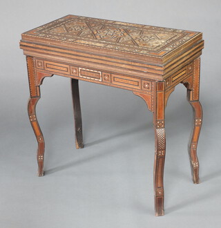 A 19th/20th Century Damascus inlaid card table with swivel top, the interior inlaid a cribbage board, raised on cabriole supports 86cm h x 85cm w x 43cm d 