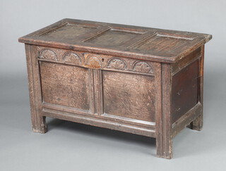 An 18th Century oak coffer of panelled construction with hinged lid and carved arcaded front panel 60cm h x 99cm w x 51cm d 