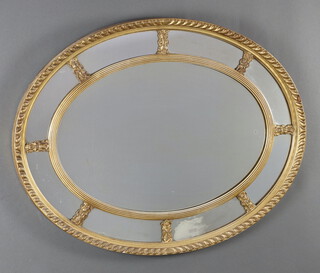 A Georgian style oval plate mirror contained a decorative gilt frame 60cm h x 77cm w  