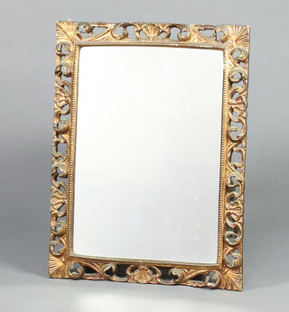 A rectangular plate mirror contained in a carved pierced gilt wood frame 73cm h x 56cm d 