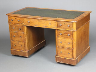 A Victorian light oak kneehole desk with green leather inset writing surface above 1 long and 8 short drawers 73cm h x 121cm w x 65cm d 