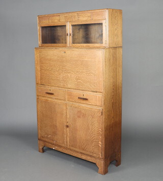 Minty, a 1930's Art Deco oak students bureau, the upper section enclosed by a panelled door above a fall front revealing a fitted interior with pigeon holes, with 2 short and cupboard enclosed by a panelled door below, the top with silver presentation plaque "Presented to A Cameron Esquire, Head Postmaster, by the post office staff in Orkney on the occasion of his retirement to Haywards Heath May 6th 1939" 149cm h x 89cm w x 30cm d  