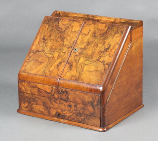 A Victorian figured walnut wedge shaped stationery box with stepped interior, 2 associated glass inkwells, replacement perpetual calendar and drawer to the base 36cm h x 41cm w x 31cm d 