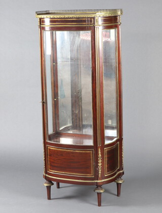 A bow front vitrine with pink veined marble top and pierced gilt gallery and gilt metal mounts throughout, the shelved interior enclosed by glazed panelled doors, raised on turned supports 156cm h x 68cm w x 43cm d 