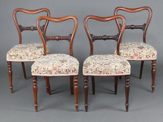 A set of  4 Victorian rosewood spoon back dining chairs with carved mid rails and over stuffed seats, raised on turned supports 83cm h x 44cm w x 38cm d 