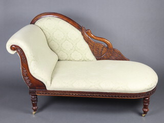 A William IV style carved and pierced mahogany chaise longue upholstered in green material 96cm h x 130cm w x 70cm d (seat 90cm x 53cm) 