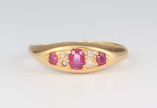 A Victorian 18ct yellow gold ruby and diamond ring comprising 3 oval cut rubies and 3 (ex 4) diamonds size N, 2.7 grams 