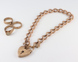 A 9ct yellow gold bracelet with heart padlock together with a 9ct charm, 12.58 grams, the bracelet 16cm 